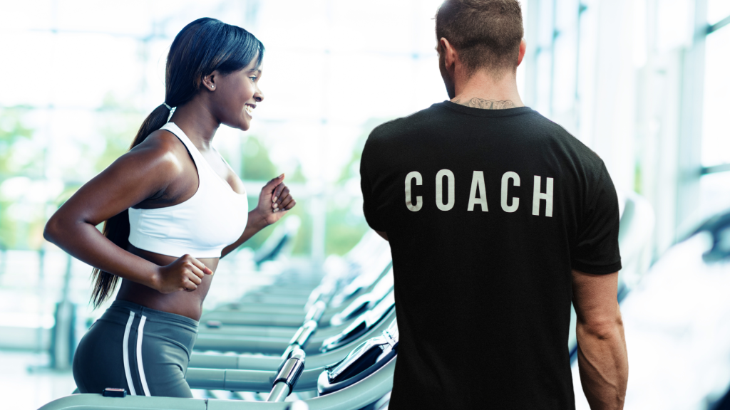 A coach observing a runner on a treadmill for a running form analysis