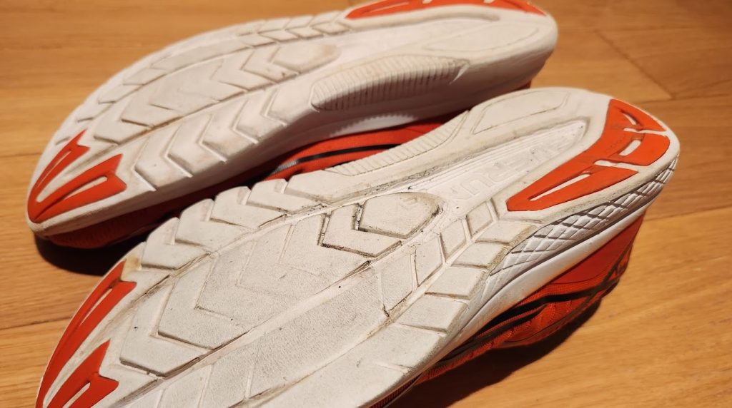 The worn out sole of a pair of running shoes indicating it is time to replace the shoes in order to avoid injuries such as shin splints.
