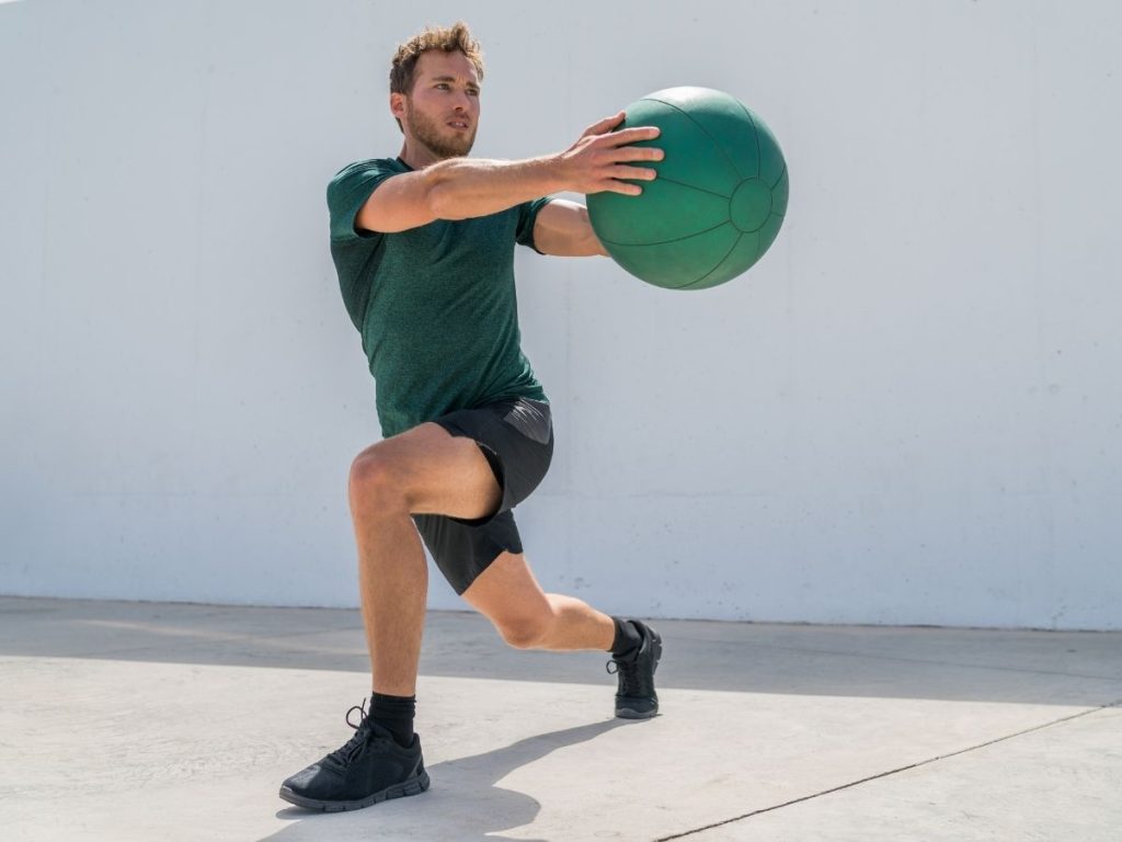 A runner performing a core strength exercise to improve his running speed and injury resistance
